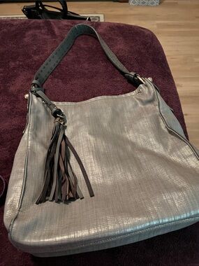 Sondra Roberts Slouch Metallic Gray Purse with Tassel Accent